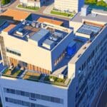 Vista aérea de edificios escolares y tecnológicos con un paisaje urbano moderno bajo un cielo despejado