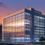 Edificio moderno con oficinas de una start-up tecnológica al atardecer, diseño limpio y profesional.