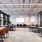 Interior moderno de un espacio de coworking con mobiliario elegante y dispositivos tecnológicos
