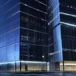 Edificios modernos en un centro financiero con luces tecnológicas en el ocaso