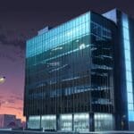 Edificio corporativo moderno en un entorno urbano tecnológico al amanecer