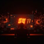 Usuario frustrado frente a pantalla con errores en Windows 11, simbolizando bugs y pérdida de confianza en experiencia de software tecnológico.