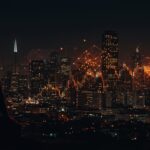 Silueta de fundador de startup con el ecosistema tecnológico de IA de San Francisco y representación visual del estancamiento económico.